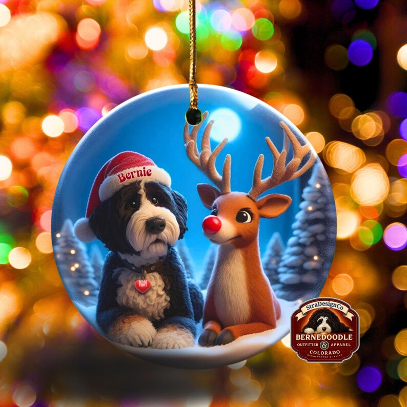 A fluffy Bernedoodle sits beside a gentle reindeer with a glowing red nose in a snowy winter forest. Soft blue and golden holiday lighting highlights the animals as snow falls around them. The Bernedoodle’s expressive face and the reindeer’s warm glow create a peaceful, magical Christmas scene perfect for woodland and dog-themed holiday décor.
