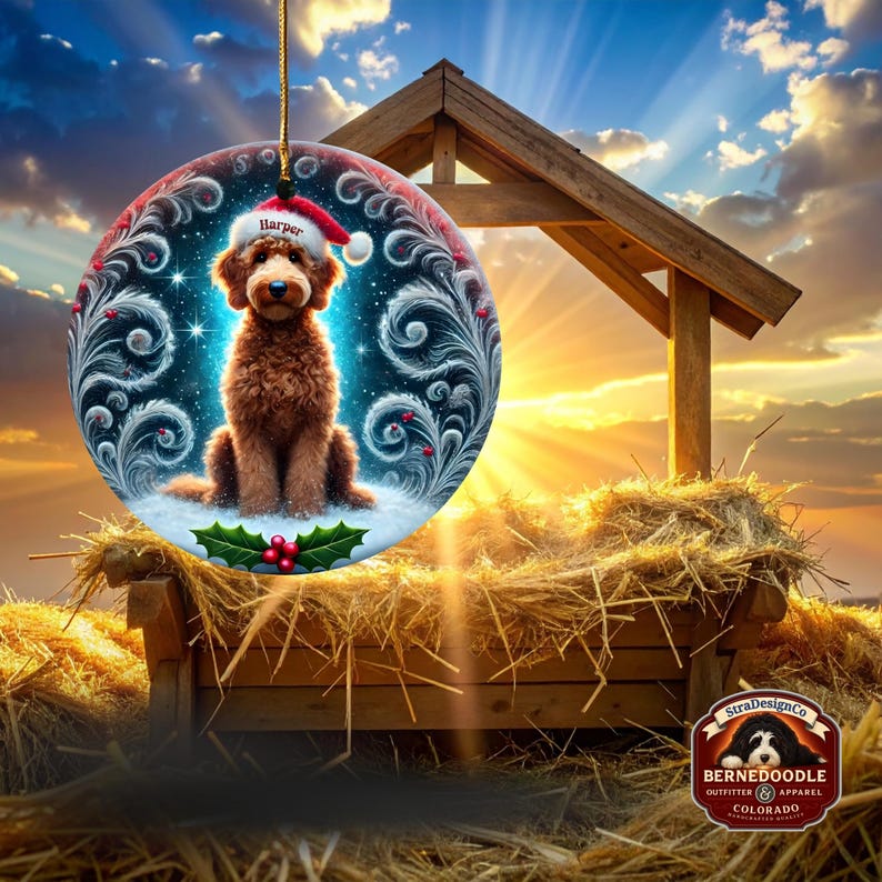 Round ceramic Christmas ornament featuring a fluffy brown goldendoodle sitting in snowy glitter. The dog wears a red Santa hat with white trim and the name “Harper.” Swirling icy feather details, blue starry background, and holly berries add a festive holiday feel. Warm lights glow behind it, making it a cozy décor piece for pet lovers and doodle families.