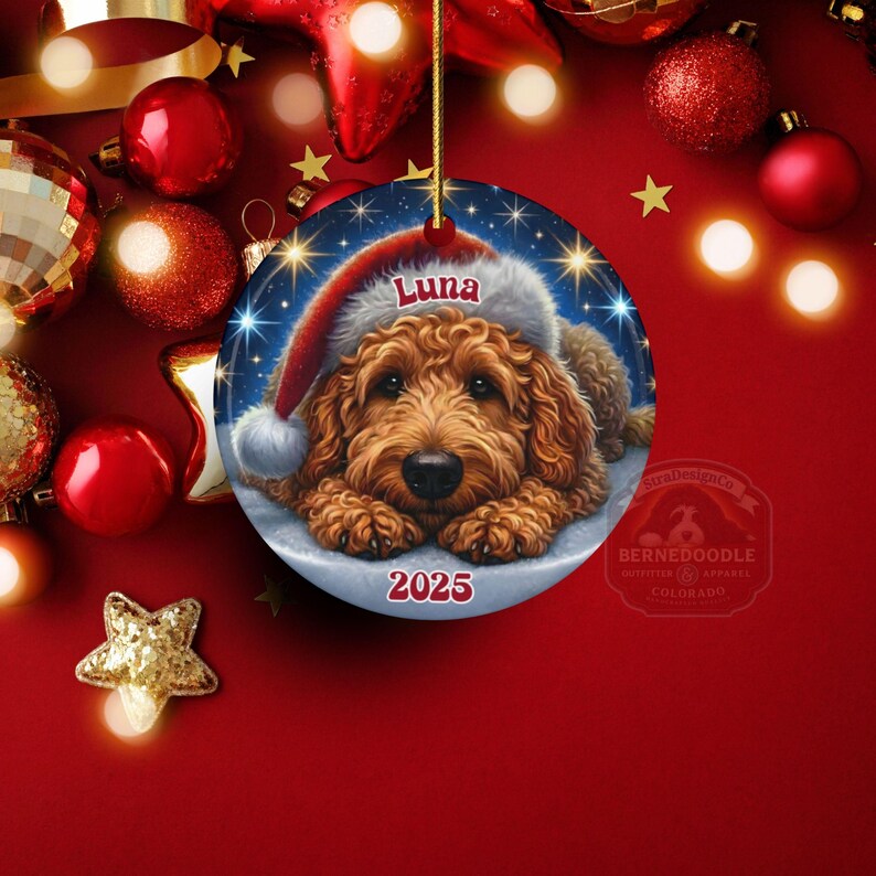A ceramic ornament of a goldendoodle dog wearing a Santa hat, personalized with the dog's name and the year.  Gorgeously placed in a warm background with candles and Christmas lights.