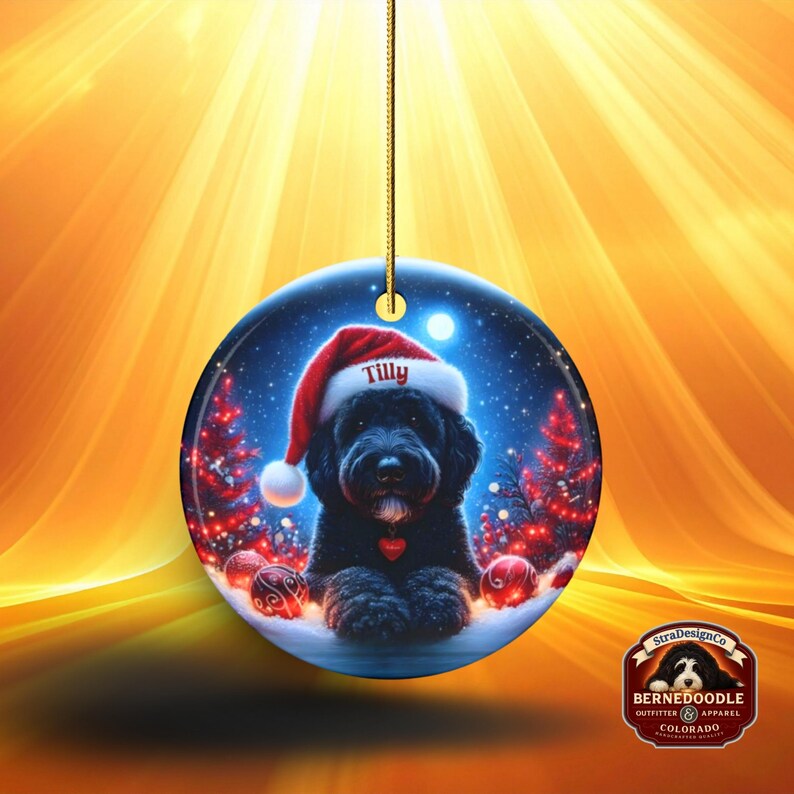 This festive ornament features an adorable black doodle wearing a Santa hat, surrounded by soft glowing holiday lights and rich red Christmas tones. The warm lighting highlights the dog’s fluffy black fur, giving the design a bright, cheerful look that stands out on any tree. A perfect personalized keepsake for anyone who loves black doodles and joyful holiday décor.