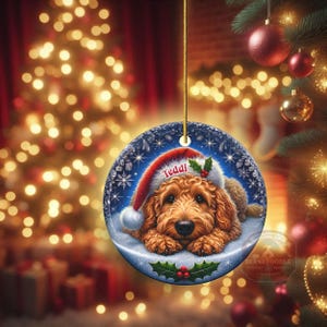 Golden Doodle dog ceramic ornament show hanging with a gold string.  The Goldendoodle Dog ornament measures 3 inches in diameter and is a full gloss, printed on both sides.