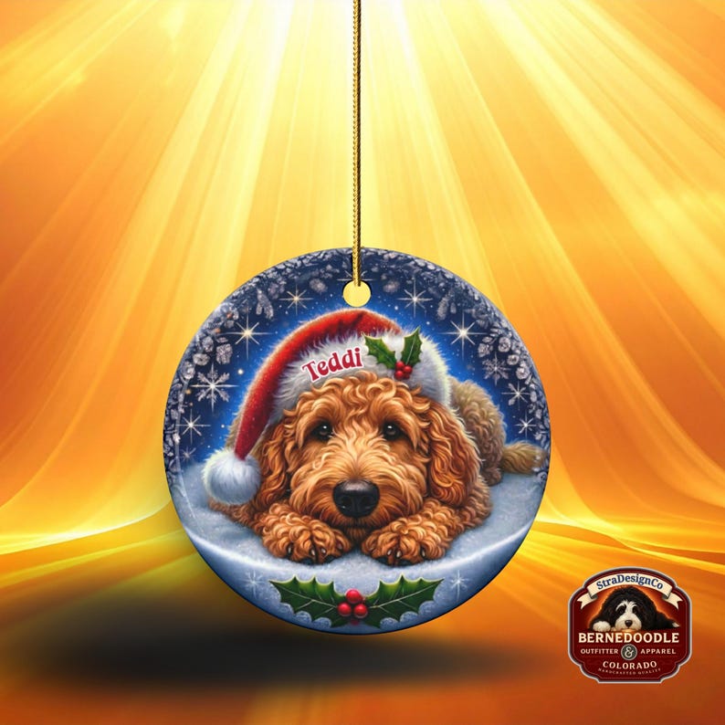 Golden Doodle dog ceramic ornament show hanging with a gold string.  The Goldendoodle Dog ornament measures 3 inches in diameter and is a full gloss, printed on both sides.