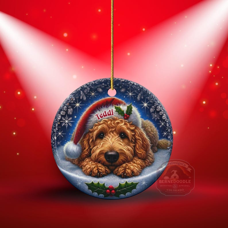 Golden Doodle dog ceramic ornament show hanging with a gold string.  The Goldendoodle Dog ornament measures 3 inches in diameter and is a full gloss, printed on both sides.