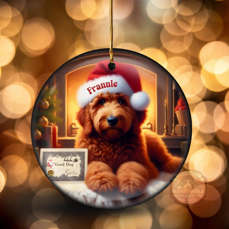 Goldendoodle Ornament - 3 inch round ceramic fully gloss Christmas Ornament hanging with a gold string against a warm background.