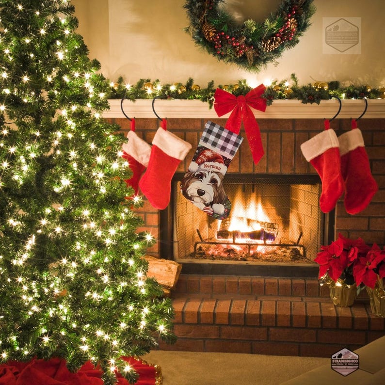 A festive Christmas stocking featuring a whimsical illustrated doodle dog wearing a red Santa hat, surrounded by holiday ornaments and greenery in a warm, detailed Christmas art style. The top of the stocking has a classic red and black buffalo-plaid cuff, and the stocking hangs from a white mantel decorated with evergreen garland and gold ornaments. The stocking design is personalized with your dog’s name, making it a charming and custom holiday décor piece for dog lovers.