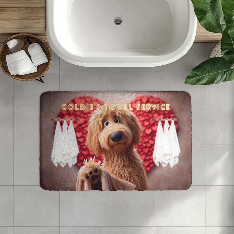 A cute golden doodle stands in front of a fluffy red heart backdrop, holding a brown towel on a cozy bath mat. White towels hang on either side, creating a spa-like feel. The text “Goldie’s Towel Service” sits above the doodle. Perfect for dog lovers, bathroom décor, and pet-themed home accents.