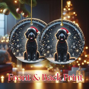 May include: Two round Christmas ornaments featuring a black dog wearing a Santa hat and red collar. The ornaments have a winter scene background with snowflakes and stars. The text "Front & Back Print" is at the bottom.