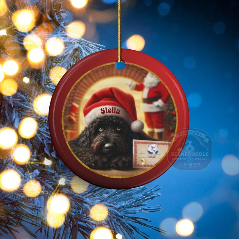 This ceramic ornament features a cute black goldendoodle (or Labradoodle)...Or black bernedoodle dog wearing a Santa hat and being on their best behavior for Santa, surrounded by holiday decorations.  Three inch ceramic dog ornament with a black bernedoodle black golden doodle black goldendoodle dog wearing a santa hat on this cute dog ornament gift.  Perfect ornament for a dog person, dog lover, doodle mom or doodle dad.