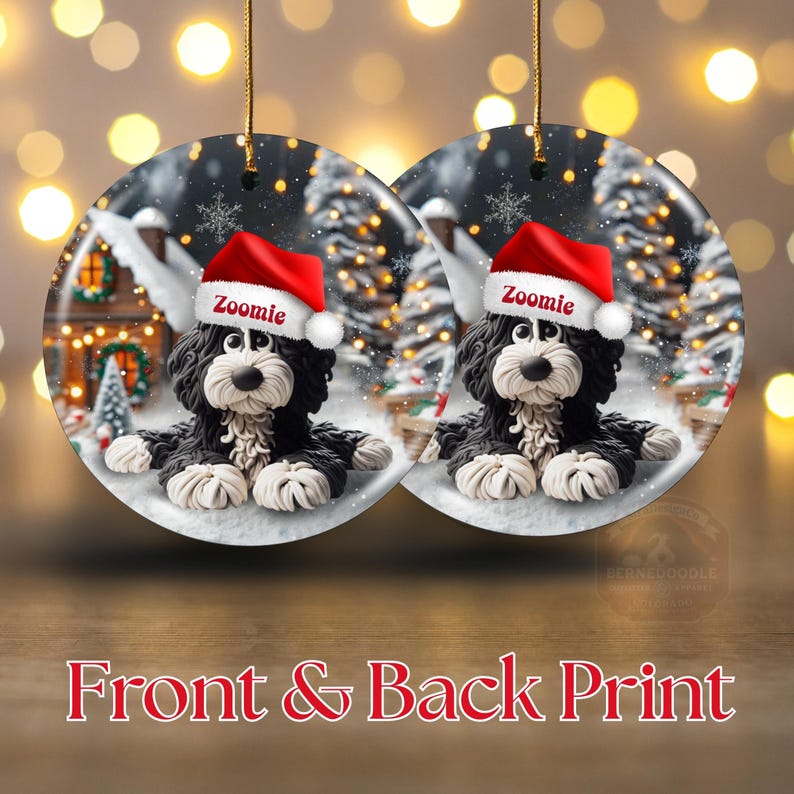 May include: Two round Christmas ornaments featuring a black and white dog wearing a red Santa hat with the name "Zoomie". The ornaments have a winter scene background with a house and trees. The text "Front & Back Print" is at the bottom.