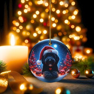 This festive ornament features an adorable black doodle wearing a Santa hat, surrounded by soft glowing holiday lights and rich red Christmas tones. The warm lighting highlights the dog’s fluffy black fur, giving the design a bright, cheerful look that stands out on any tree. A perfect personalized keepsake for anyone who loves black doodles and joyful holiday décor.