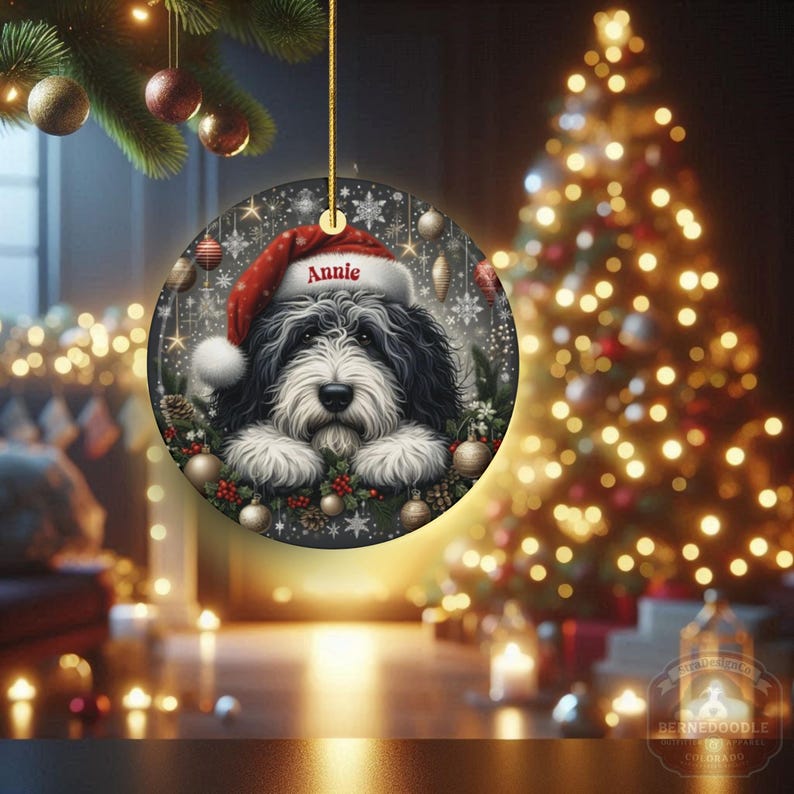 Sheepadoodle custom ornament on display with glowing lights in the background.  This 3 inch ceramic ornament is perfect for Sheepa Doodle lovers everywhere.