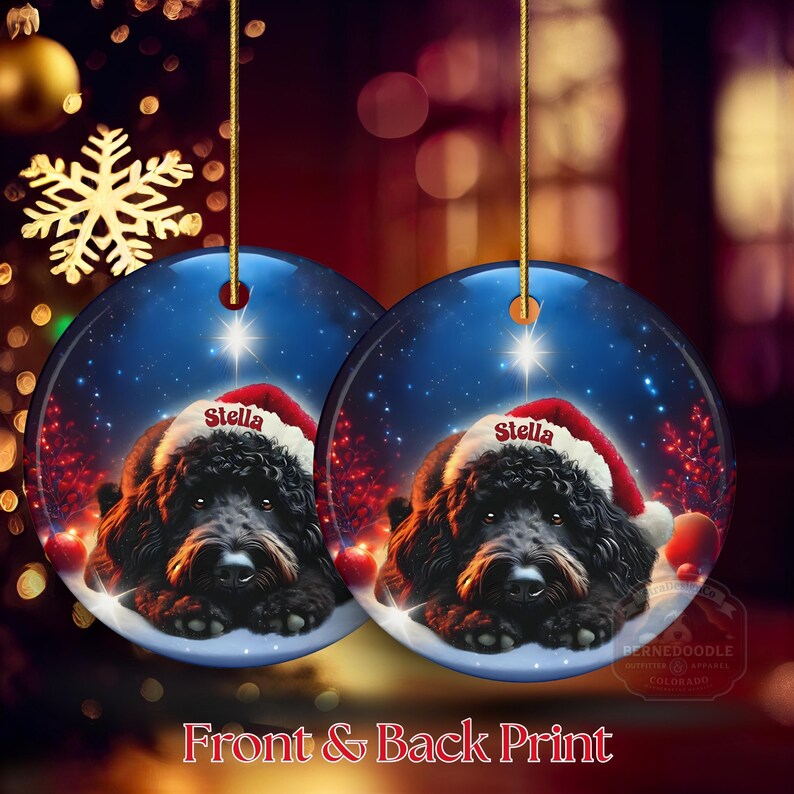 May include: Two round Christmas ornaments featuring a black dog wearing a Santa hat with the name "Stella". The ornaments have a blue background with a starry night scene and red accents. The text "Front & Back Print" is at the bottom.