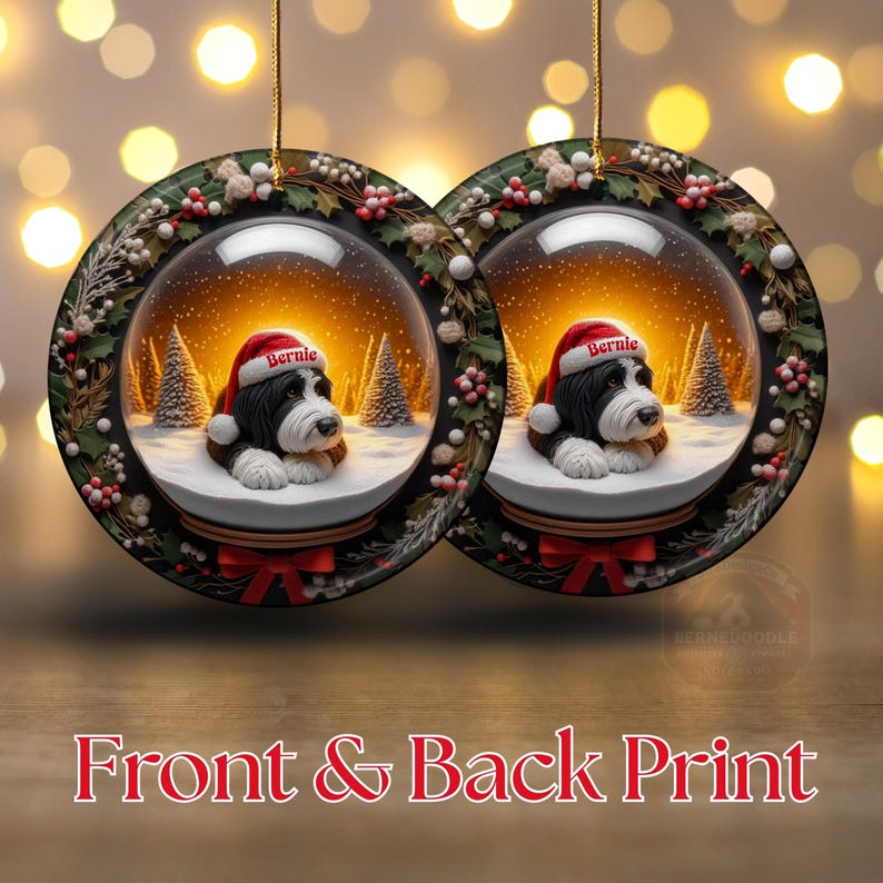May include: Two round Christmas ornaments featuring a snow globe design with a dog wearing a Santa hat. The ornaments have a black and white dog with the name "Bernie" on the hat, set against a snowy landscape with Christmas trees. The text "Front & Back Print" is at the bottom.