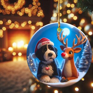 A fluffy Bernedoodle sits beside a gentle reindeer with a glowing red nose in a snowy winter forest. Soft blue and golden holiday lighting highlights the animals as snow falls around them. The Bernedoodle’s expressive face and the reindeer’s warm glow create a peaceful, magical Christmas scene perfect for woodland and dog-themed holiday décor.