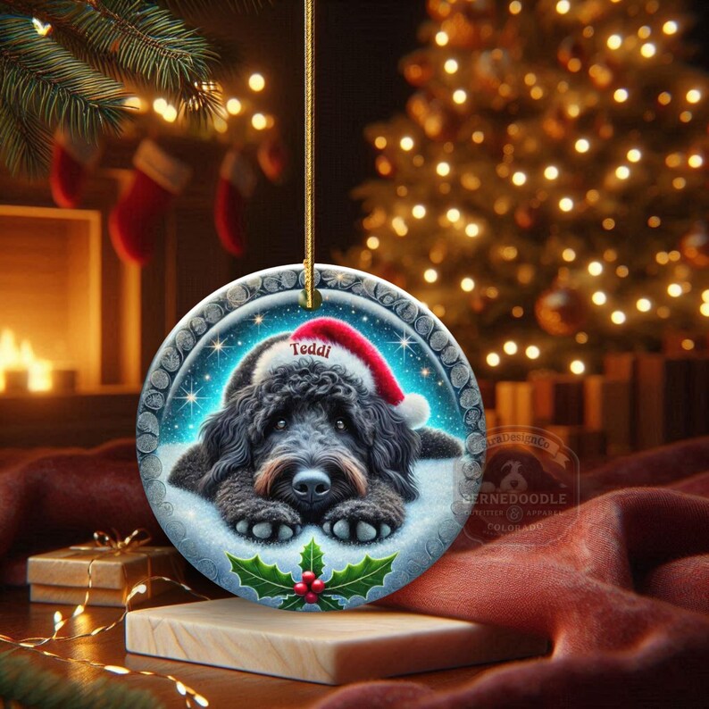 Black goldendoodle ceramic ornament with two sided design.  Black golden doodle , black bernedoodle dog decor.  The picture is showing the ornaments printed on each side.  Gorgeous blue ornament with black doodle dog wearing a santa hat.  Personalized with dog's name.