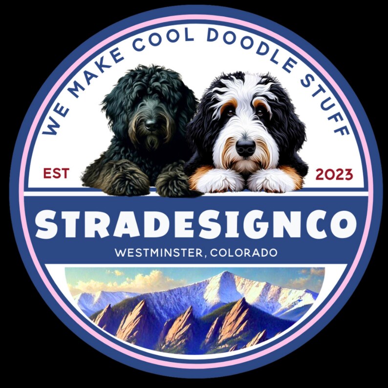 May include: A circular logo featuring a black dog and a tri-color doodle dog above the text STRADESIGNCO, WESTMINSTER, COLORADO, EST 2023, and WE MAKE COOL DOODLE STUFF. The bottom section displays a mountain range with snow-capped peaks under a blue sky.