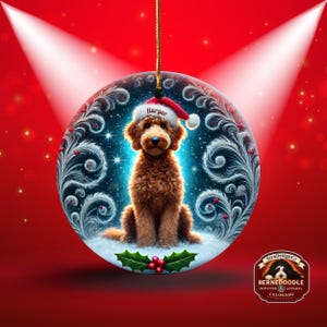 A cozy Christmas ornament featuring a goldendoodle sitting in fluffy snow while wearing a Santa hat with the name “Harper.” Frosty feather-style swirls, glittering stars, and holly berries add decorative flair. The glowing background lights create warmth and charm, making it ideal as a personalized gift or tree decoration.