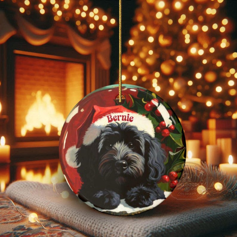 A black bernedoodle dog wearing a santa hat that is personalized with their name on it in this adorable Ceramic ornament!  Design appears on the front and the back of this doodle dog ornament!