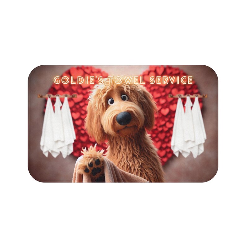A cute golden doodle stands in front of a fluffy red heart backdrop, holding a brown towel on a cozy bath mat. White towels hang on either side, creating a spa-like feel. The text “Goldie’s Towel Service” sits above the doodle. Perfect for dog lovers, bathroom décor, and pet-themed home accents.