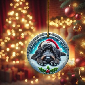 Black goldendoodle ceramic ornament with two sided design.  Black golden doodle , black bernedoodle dog decor.  The picture is showing the ornaments printed on each side.  Gorgeous blue ornament with black doodle dog wearing a santa hat.  Personalized with dog's name.