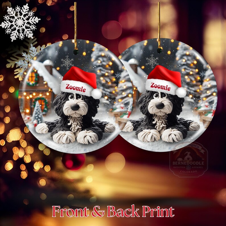 May include: Two round Christmas ornaments featuring a black and white dog wearing a red Santa hat with the name "Zoomie". The ornaments have a winter scene background with snow, trees, and a house. The text "Front & Back Print" is at the bottom.