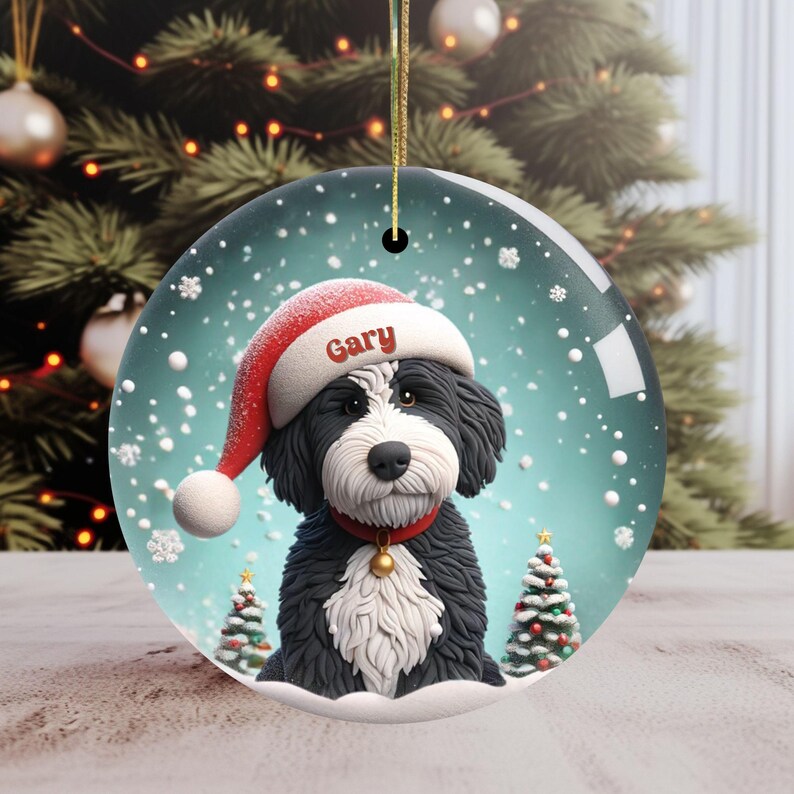 Celebrate the holidays with this adorable Bernedoodle Christmas ornament! Featuring a charming claymation-style Bernie in a Santa hat, surrounded by snowflakes and festive trees, this ornament adds warmth and joy to any holiday decor. For dog lovers!