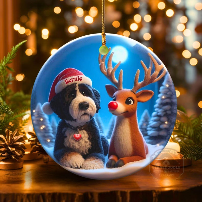 A fluffy Bernedoodle sits beside a gentle reindeer with a glowing red nose in a snowy winter forest. Soft blue and golden holiday lighting highlights the animals as snow falls around them. The Bernedoodle’s expressive face and the reindeer’s warm glow create a peaceful, magical Christmas scene perfect for woodland and dog-themed holiday décor.