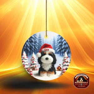 Bernedoodle claymation style ornament made of ceramic, hanging by a gold string.  Winter scene featuring a cute, personalized doodle dog with personalized name on santa hat.  Perfect gift for Bernedoodle Dog Lovers and Pet Enthusiasts.
