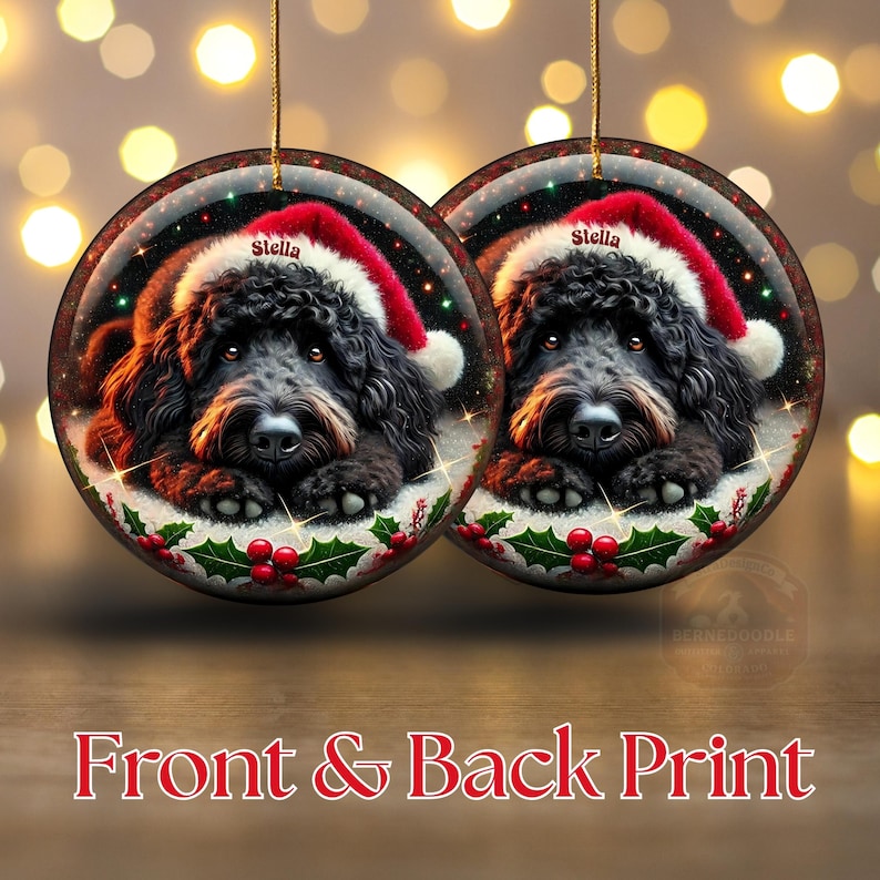 May include: Two round Christmas ornaments featuring a black dog wearing a Santa hat with the name "Stella". The ornaments have a festive design with holly and berries. The text "Front & Back Print" is at the bottom.