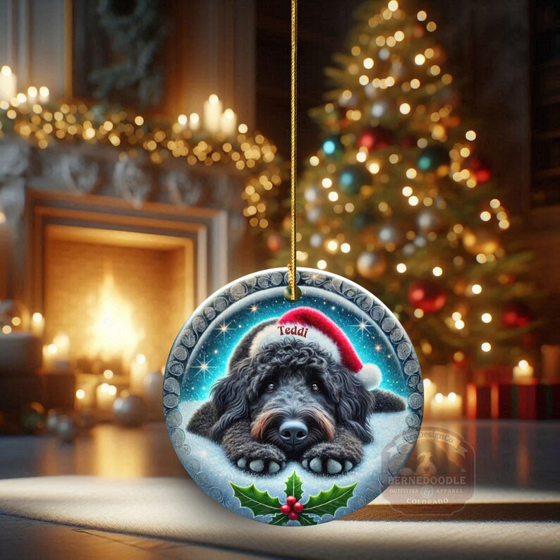 Black goldendoodle ceramic ornament with two sided design.  Black golden doodle , black bernedoodle dog decor.  The picture is showing the ornaments printed on each side.  Gorgeous blue ornament with black doodle dog wearing a santa hat.  Personalized with dog's name.