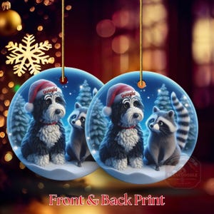 A 3-inch double-sided ceramic Christmas ornament featuring an adorable claymation-style Bernedoodle wearing a red Santa hat personalized  sitting beside a cute raccoon under a snowy winter night sky. The ornament has crisp detailing, soft blue tones, and a warm Christmas glow in the blurred background. Perfect for Bernedoodle lovers, handmade Christmas gift shoppers. High-quality ceramic with vibrant colors, ideal for tree decorating, pet memorial ornaments, or festive seasonal displays.