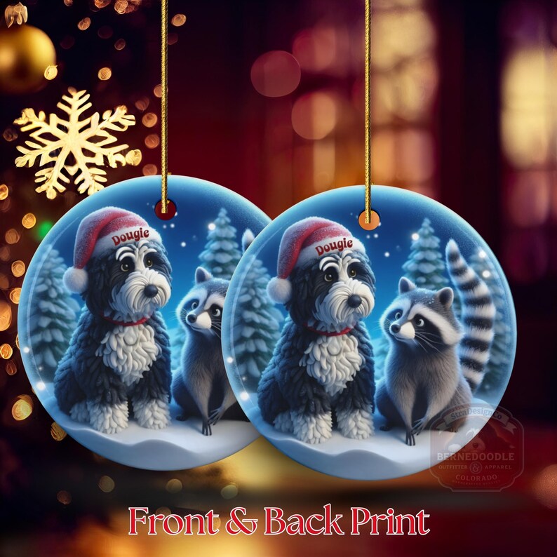 A 3-inch double-sided ceramic Christmas ornament featuring an adorable claymation-style Bernedoodle wearing a red Santa hat personalized  sitting beside a cute raccoon under a snowy winter night sky. The ornament has crisp detailing, soft blue tones, and a warm Christmas glow in the blurred background. Perfect for Bernedoodle lovers, handmade Christmas gift shoppers. High-quality ceramic with vibrant colors, ideal for tree decorating, pet memorial ornaments, or festive seasonal displays.