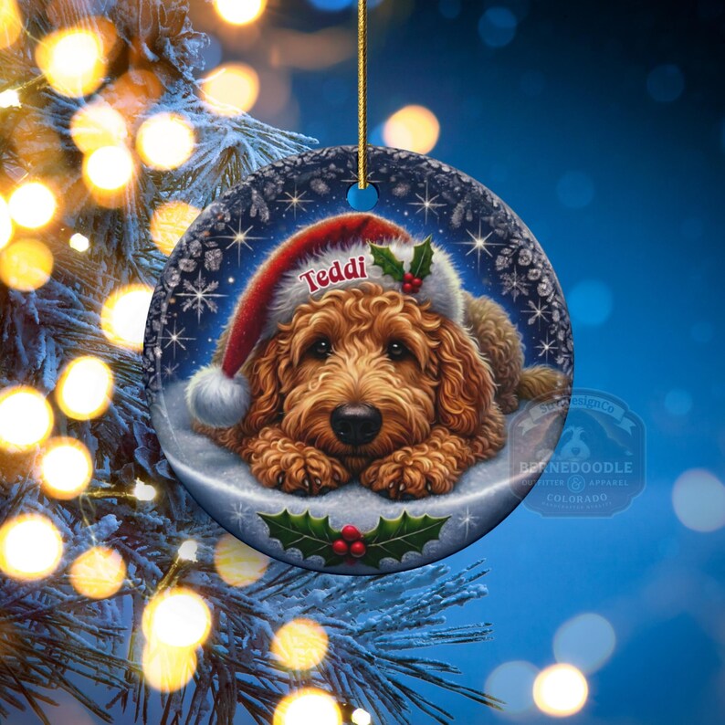 Golden Doodle dog ceramic ornament show hanging with a gold string.  The Goldendoodle Dog ornament measures 3 inches in diameter and is a full gloss, printed on both sides.