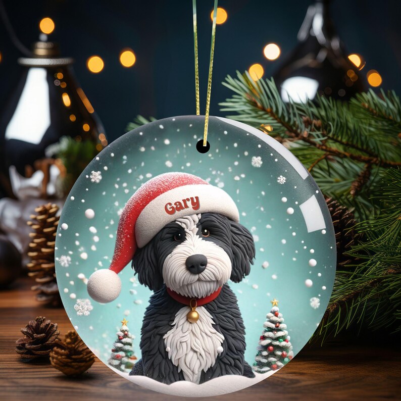 Celebrate the holidays with this adorable Bernedoodle Christmas ornament! Featuring a charming claymation-style Bernie in a Santa hat, surrounded by snowflakes and festive trees, this ornament adds warmth and joy to any holiday decor. For dog lovers!