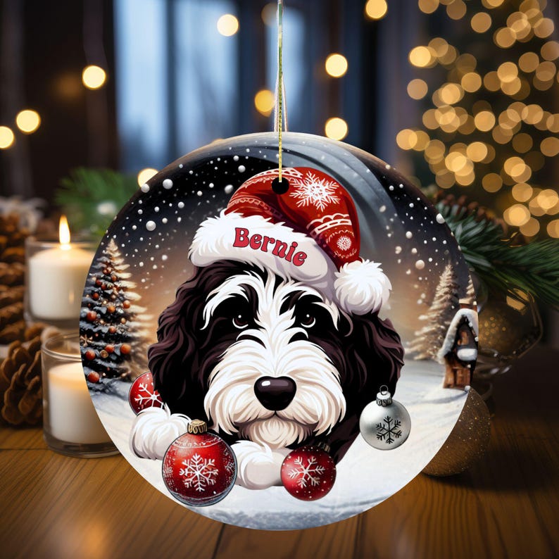 Personalize your holiday decor with this charming Bernedoodle Christmas ornament! Featuring a cute Bernedoodle in a festive Santa hat and customizable name, this round ornament adds warmth and joy to any tree. Perfect for dog lovers and unique gifts!