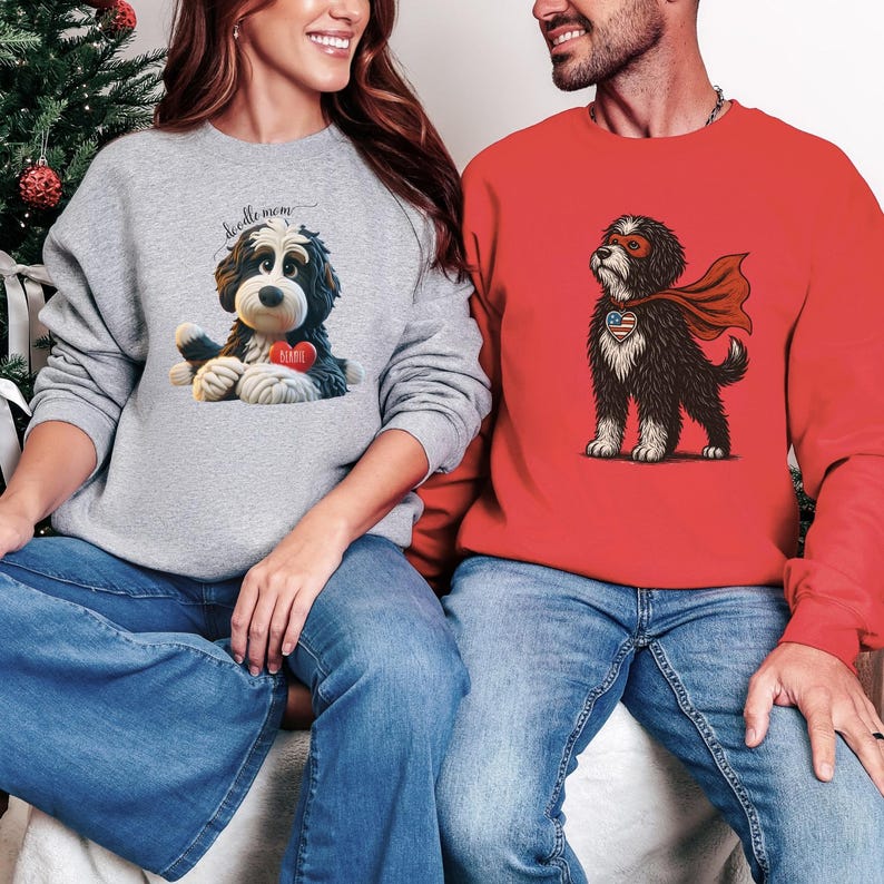 A woman wearing a Bernedoodle sweatshirt with cute design on the front and the back.  The front features a bernedoodle dog in claymation design holding a heart with his name, across the top of his head the words, "Doodle Mom", on the back, it shows the bernedoodle laying rear view with the pads of his doodle feet flipped back in a cute pose, with a heart and the words, "Doodle Mom".