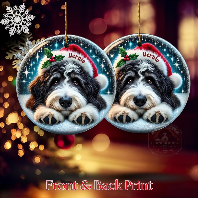 May include: Two round Christmas ornaments featuring a black and white dog wearing a Santa hat with the name "Bernie". The ornaments have a snowy background with sparkling stars and holly. The text "Front & Back Print" is at the bottom.