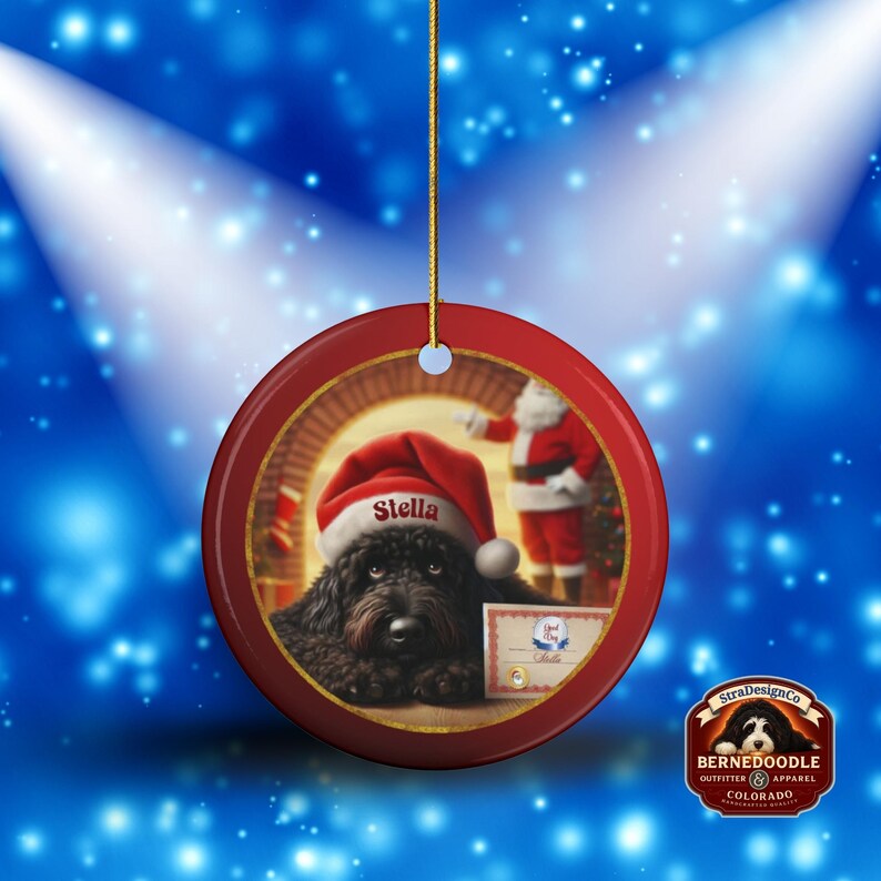 This ceramic ornament features a cute black goldendoodle (or Labradoodle)...Or black bernedoodle dog wearing a Santa hat and being on their best behavior for Santa, surrounded by holiday decorations.  Three inch ceramic dog ornament with a black bernedoodle black golden doodle black goldendoodle dog wearing a santa hat on this cute dog ornament gift.  Perfect ornament for a dog person, dog lover, doodle mom or doodle dad.