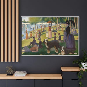 May include: Framed print of a pointillism painting depicting a park scene with people, dogs, and a lake. The artwork features a white frame and is displayed on a dark gray wall. The painting showcases a vibrant use of color and detail.