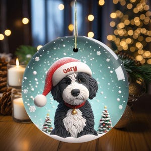 Celebrate the holidays with this adorable Bernedoodle Christmas ornament! Featuring a charming claymation-style Bernie in a Santa hat, surrounded by snowflakes and festive trees, this ornament adds warmth and joy to any holiday decor. For dog lovers!