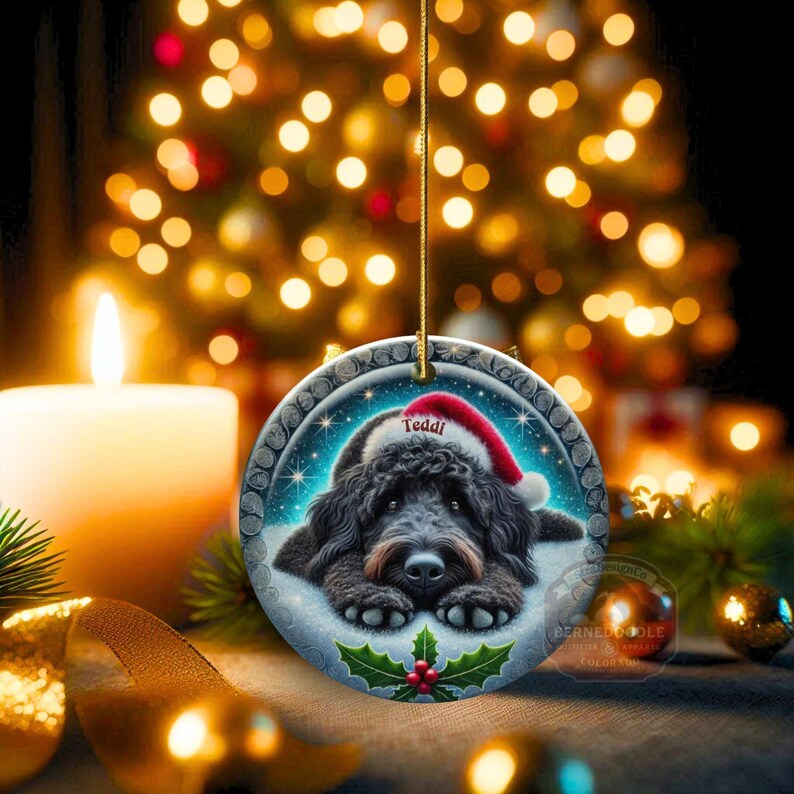 Black goldendoodle ceramic ornament with two sided design.  Black golden doodle , black bernedoodle dog decor.  The picture is showing the ornaments printed on each side.  Gorgeous blue ornament with black doodle dog wearing a santa hat.  Personalized with dog's name.