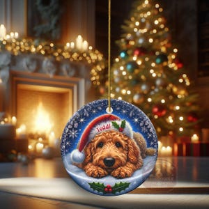 Golden Doodle dog ceramic ornament show hanging with a gold string.  The Goldendoodle Dog ornament measures 3 inches in diameter and is a full gloss, printed on both sides.