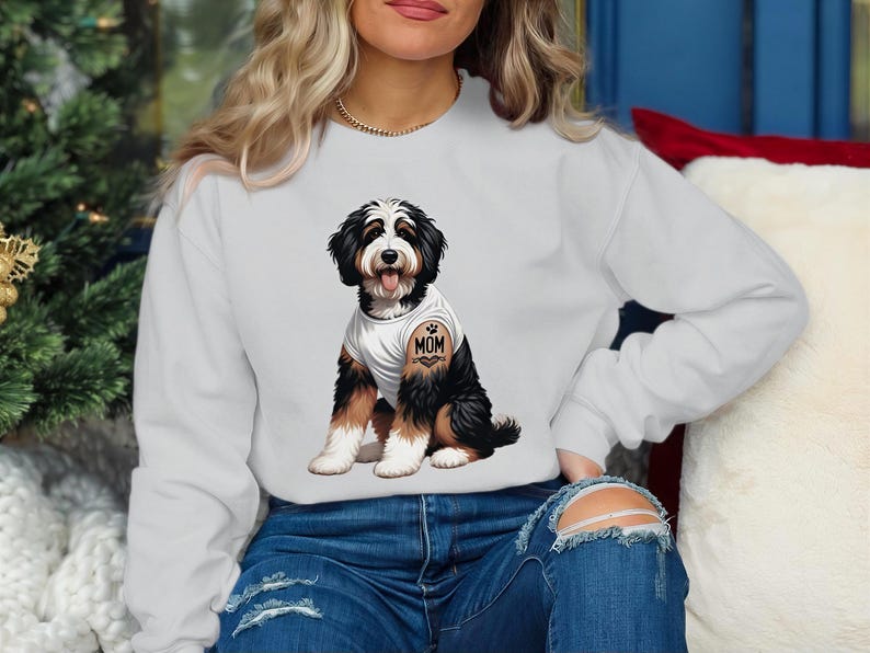 A woman wearing a white sweatshirt with a graphic of a dog on it.