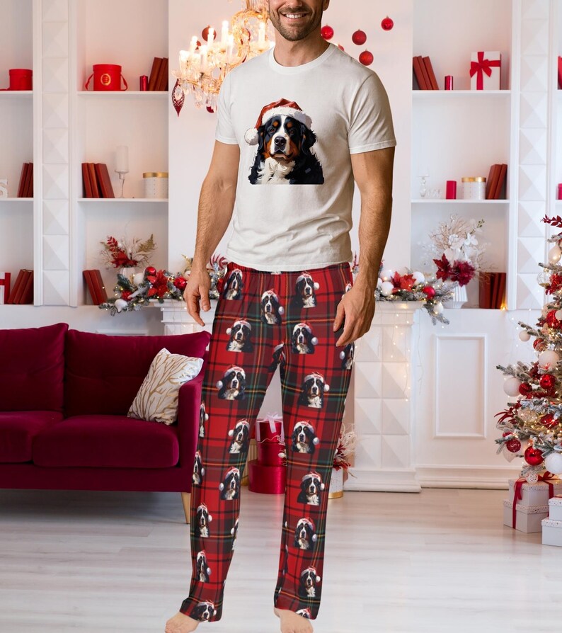 A man seen wearing Men's pajama pants lounge wear personalized Christmas pajama bottoms with Bernese Mountain dogs wearing Santa Hat and their name is on the Santa Hat.  Bernese Mountain Dog dad gear!