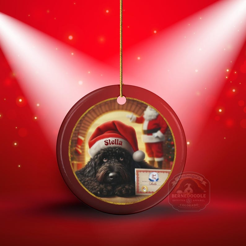 This ceramic ornament features a cute black goldendoodle (or Labradoodle)...Or black bernedoodle dog wearing a Santa hat and being on their best behavior for Santa, surrounded by holiday decorations.  Three inch ceramic dog ornament with a black bernedoodle black golden doodle black goldendoodle dog wearing a santa hat on this cute dog ornament gift.  Perfect ornament for a dog person, dog lover, doodle mom or doodle dad.