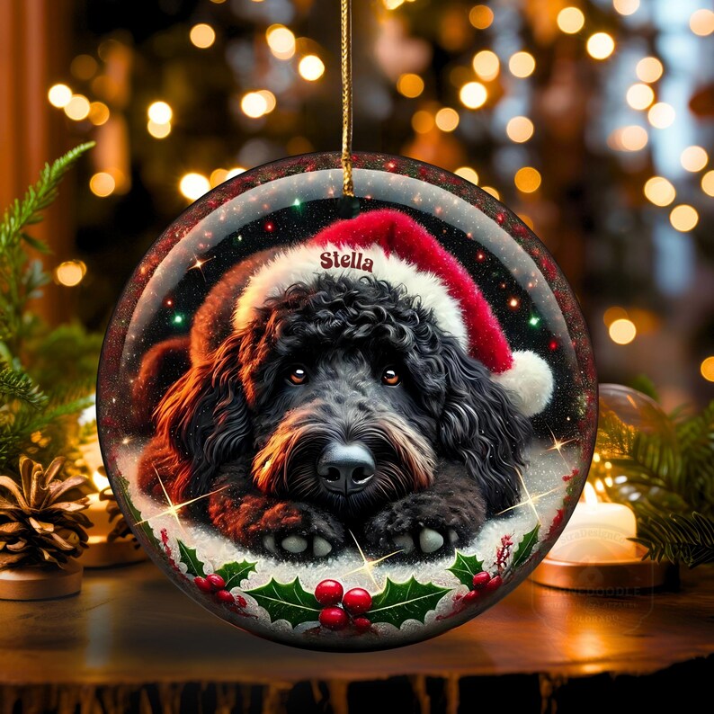 Black bernedoodle or labradoodle dog ceramic ornament show hanging with a gold string.  The ornament measures 3 inches in diameter and is a full gloss, printed on both sides.