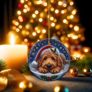 Golden Doodle dog ceramic ornament show hanging with a gold string.  The Goldendoodle Dog ornament measures 3 inches in diameter and is a full gloss, printed on both sides.