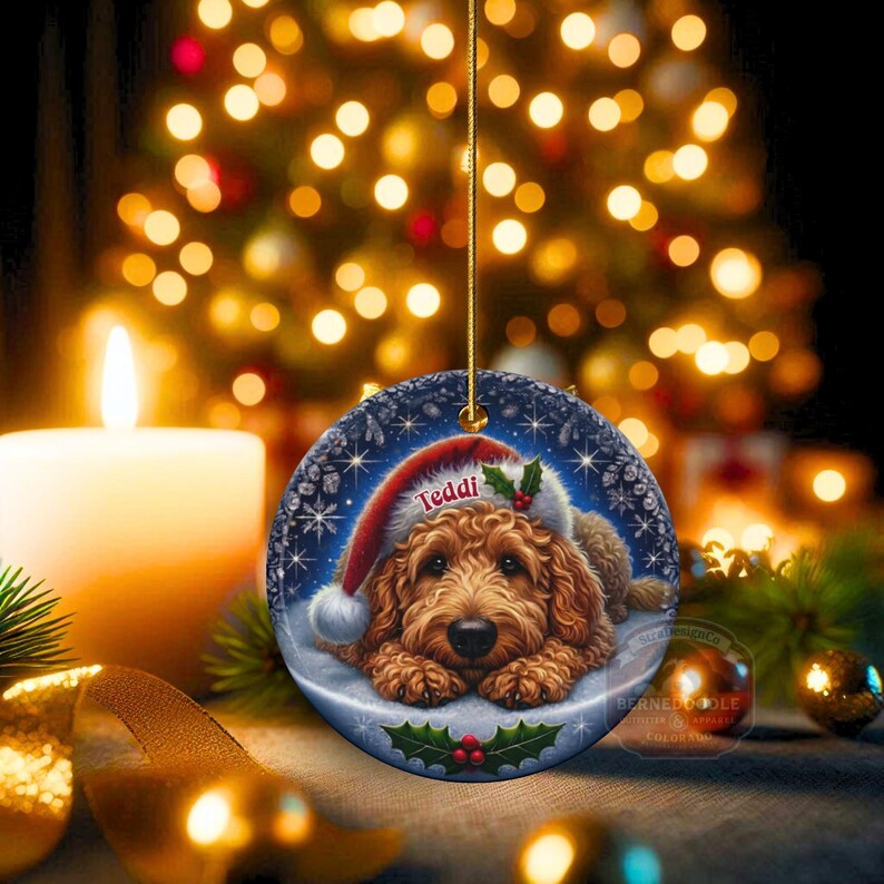 Golden Doodle dog ceramic ornament show hanging with a gold string.  The Goldendoodle Dog ornament measures 3 inches in diameter and is a full gloss, printed on both sides.
