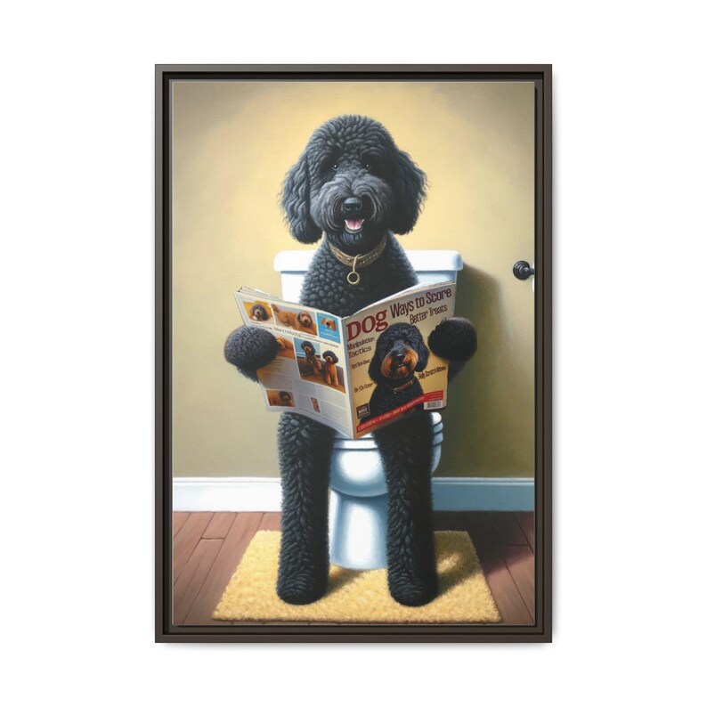 A humorous artwork features a fluffy black doodle-style dog with curly fur, sitting upright on a white toilet like a person, holding a dog magazine titled “Dog Ways to Score Better Treats.” The playful bathroom scene shows warm tan walls, a white baseboard, and wood flooring with a small beige rug under the dog’s feet. The dog gazes forward with a friendly expression, wearing a gold collar. The framed portrait blends realism and whimsy, making it perfect for bernedoodle and goldendoodle fans