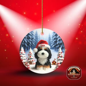 Bernedoodle claymation style ornament made of ceramic, hanging by a gold string.  Winter scene featuring a cute, personalized doodle dog with personalized name on santa hat.  Perfect gift for Bernedoodle Dog Lovers and Pet Enthusiasts.